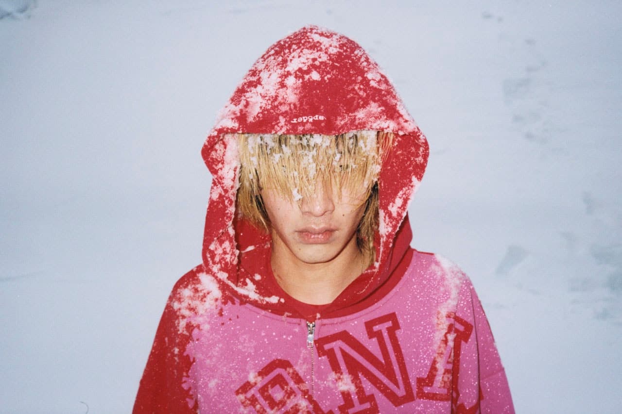 Portrait of a model wearing a red and pink graphic hoodie